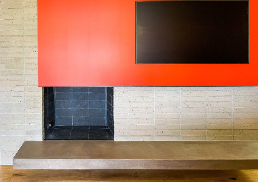 Modern brick fireplace and concrete hearth in the Pewter Brick project