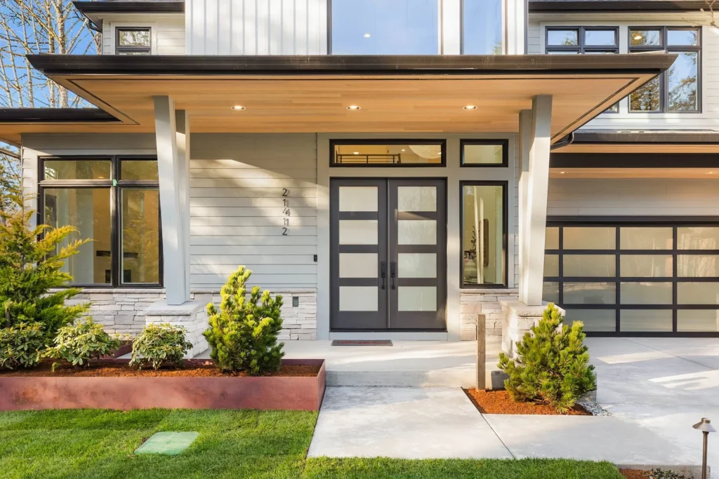 Front entry with pale stone veneer columns on The Douglas Stone project