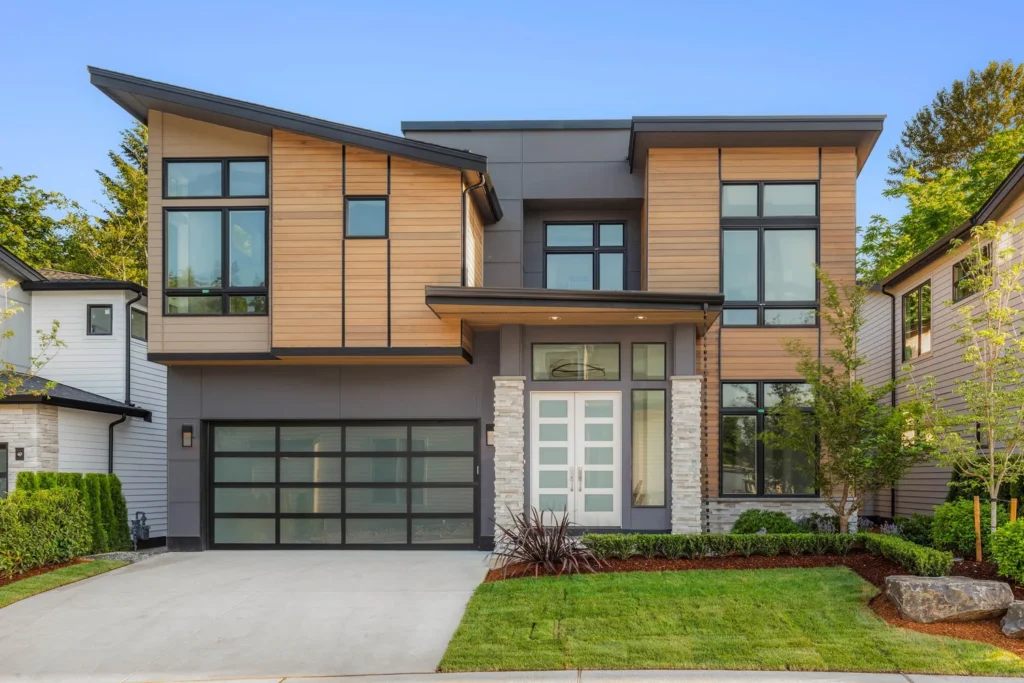 Modern home exterior with stacked stone entry detail on the Tibbets Lots project